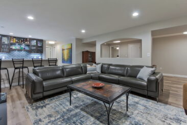 Photo of a newly renovated basement  in an Edmonton area home with a wet bar and comfortable sitting area.
