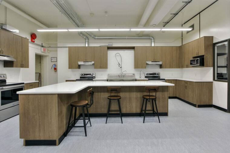 5 Commercial kitchen with brown cabinets white walls and counters