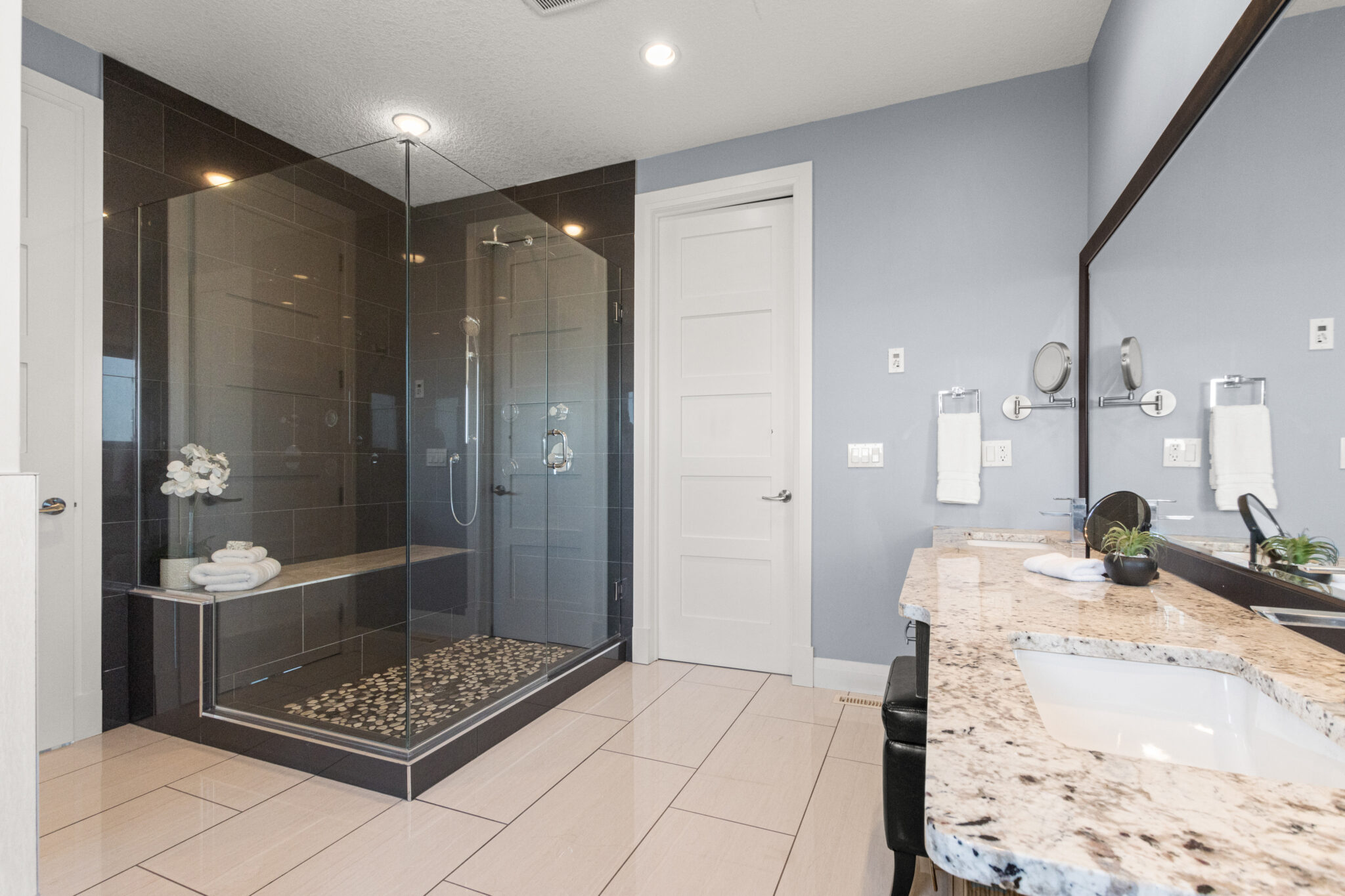 Renovated walk in shower black tile glass doors