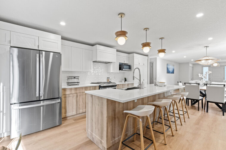 17 Bright kitchen with white cabinetry and contemporary stainless steel appliances.