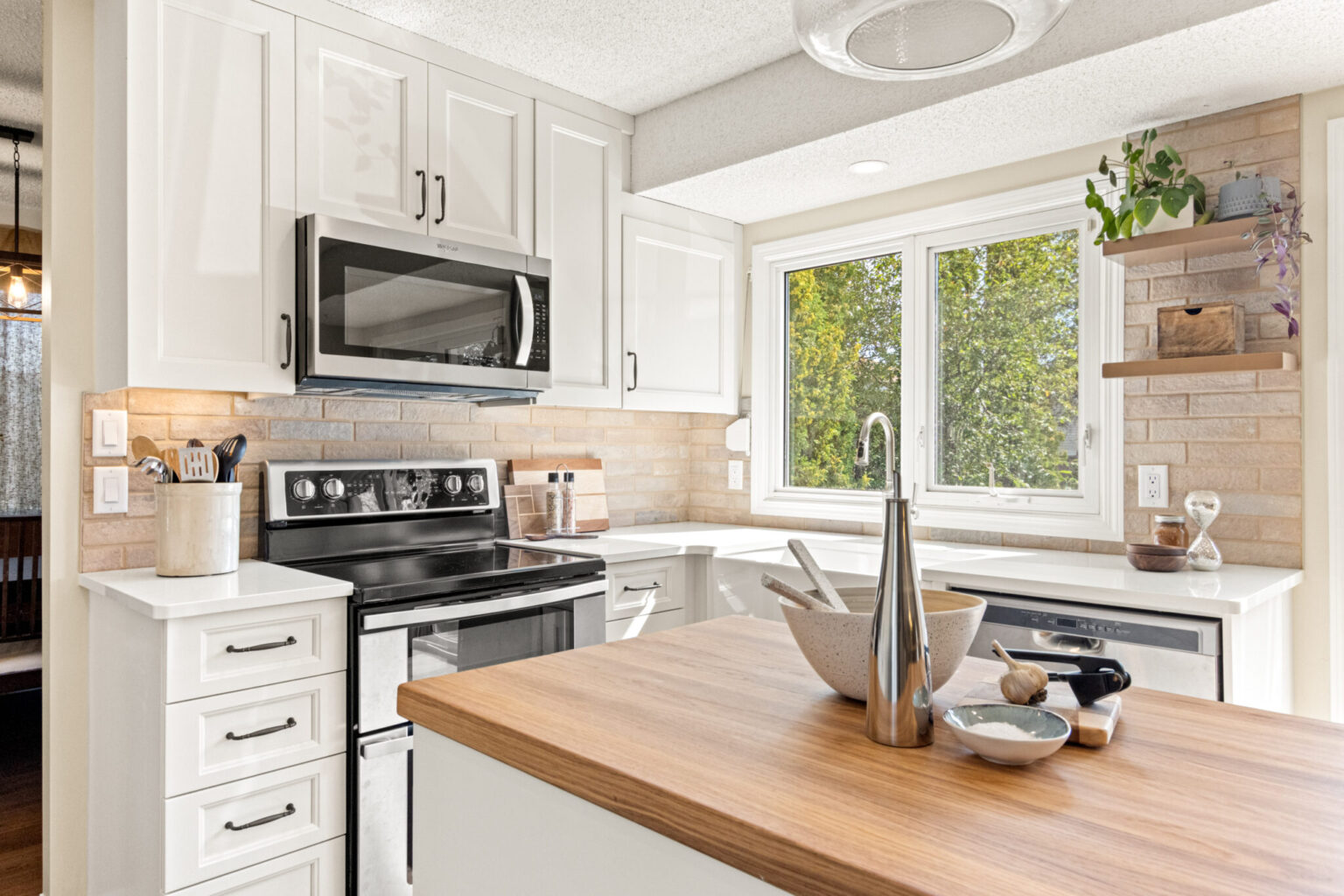A bright, airy photo of a well-designed and comfortable modern kitchen.