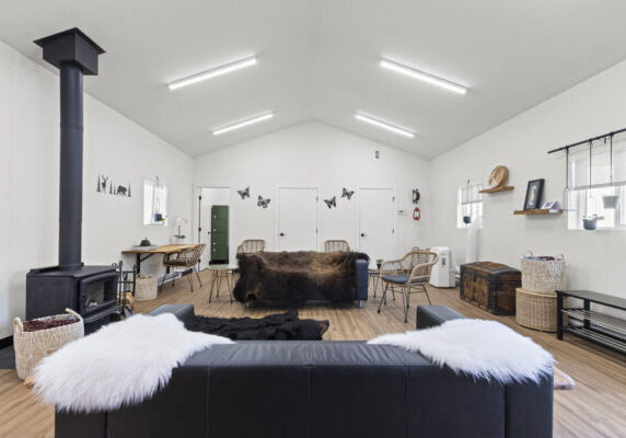 4 the interior of a community building with white walls, a bearskin rug and fireplace