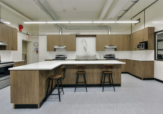 5 Commercial kitchen with brown cabinets white walls and counters